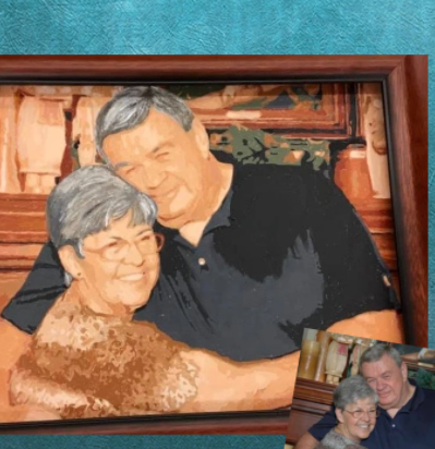 Framed portrait of an elderly couple with a decorative background